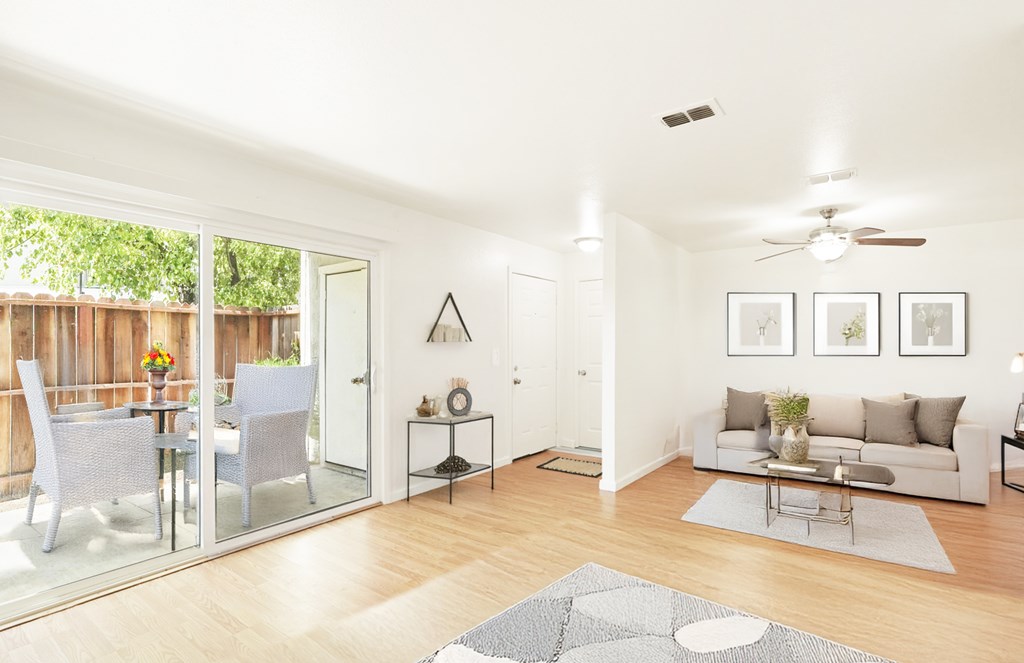 A modern living room with a glass table and chairs.