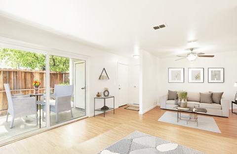 A modern living room with a glass table and chairs.