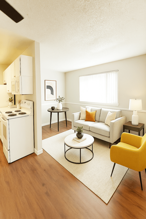 A white fridge is in a kitchen next to a white sofa.