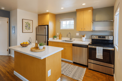 A kitchen with wooden cabinets and a white countertop.