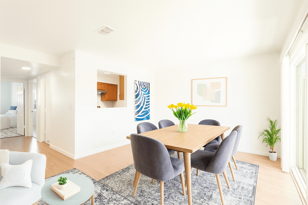 A dining room with a table set for six.