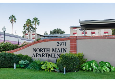 A sign for North Main Apartment 2971 is displayed in front of a building.