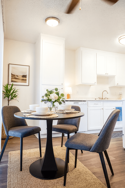 A dining room with a table and chairs.