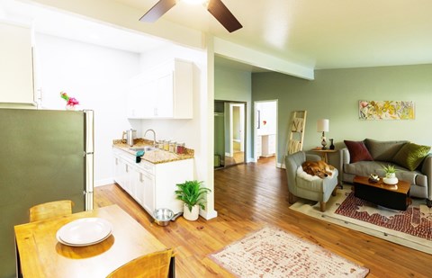 A kitchen with a table and chairs in front of it.