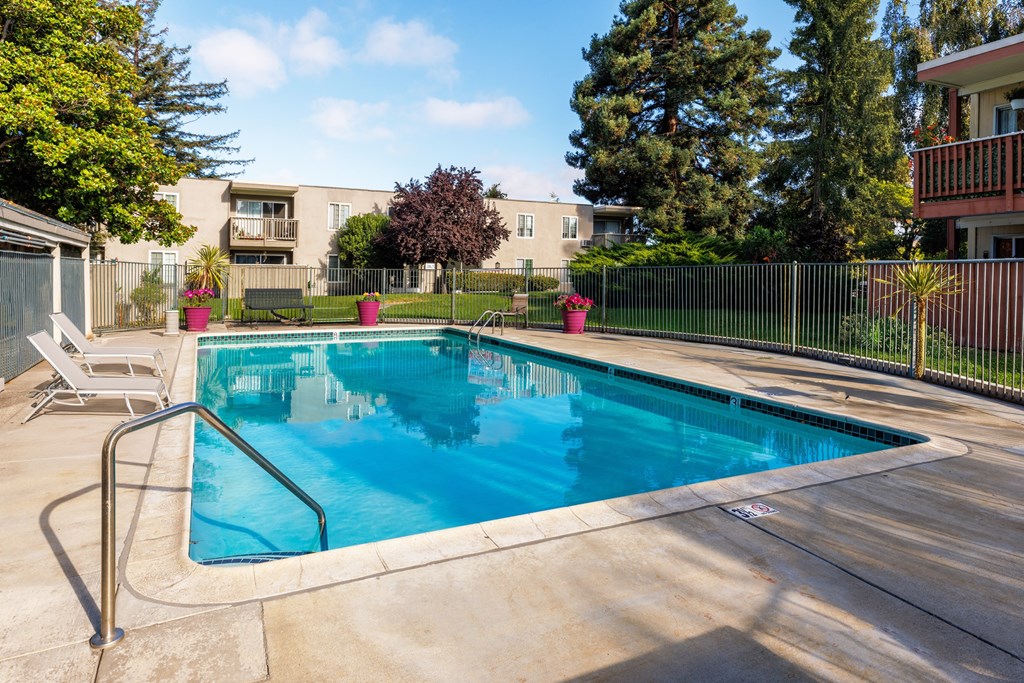 A small pool with a metal fence around it.