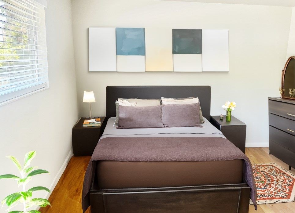a bedroom with a bed and a window