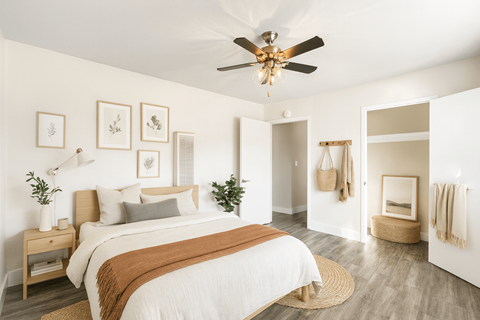 A bedroom with a bed, a ceiling fan, and a rug.