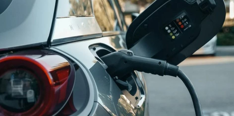 A car is being charged at a station.