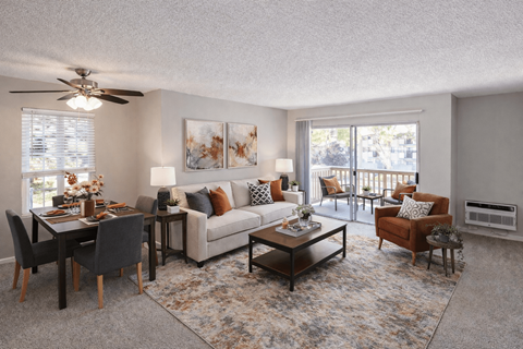 A living room with a dining table set up with chairs around it.
