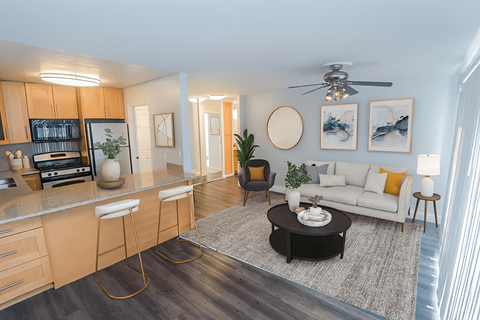 A modern kitchen with a bar stool and a coffee table.