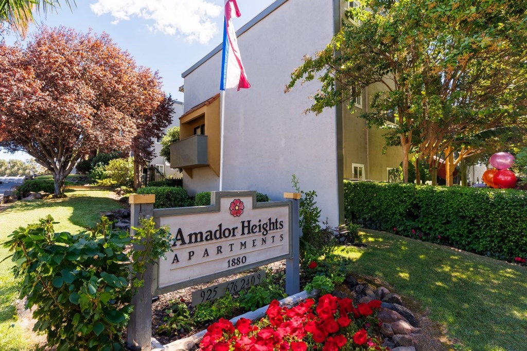A sign for Amador Heights Apartments is in front of a building.