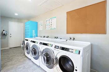A row of washing machines in a laundromat.