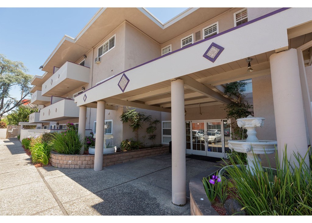 A building with a white facade and purple trim.