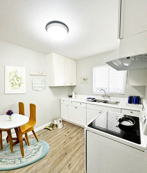 A small kitchen with a table and chairs.