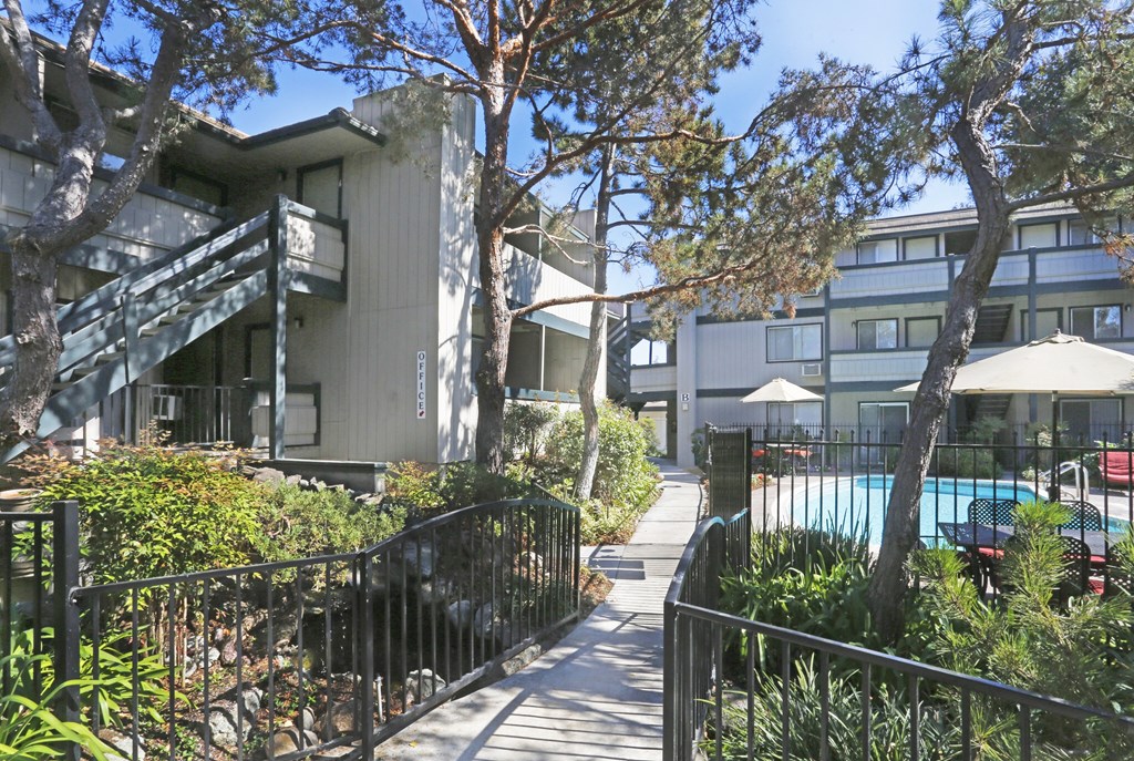 A modern building with a pool in the courtyard.