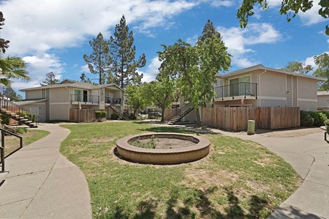 A sunny day at a residential area with a playground in the foreground.