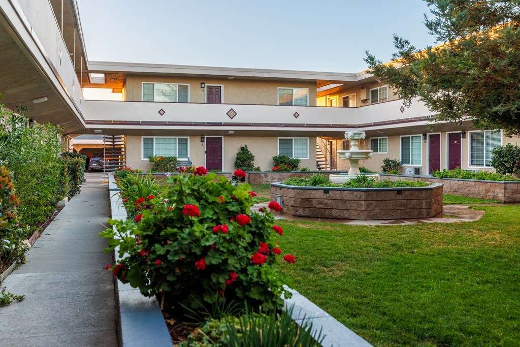 A building with a garden in front of it.