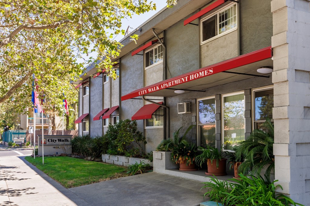 The front of a building with a red awning that says City Park Apartment Homes.