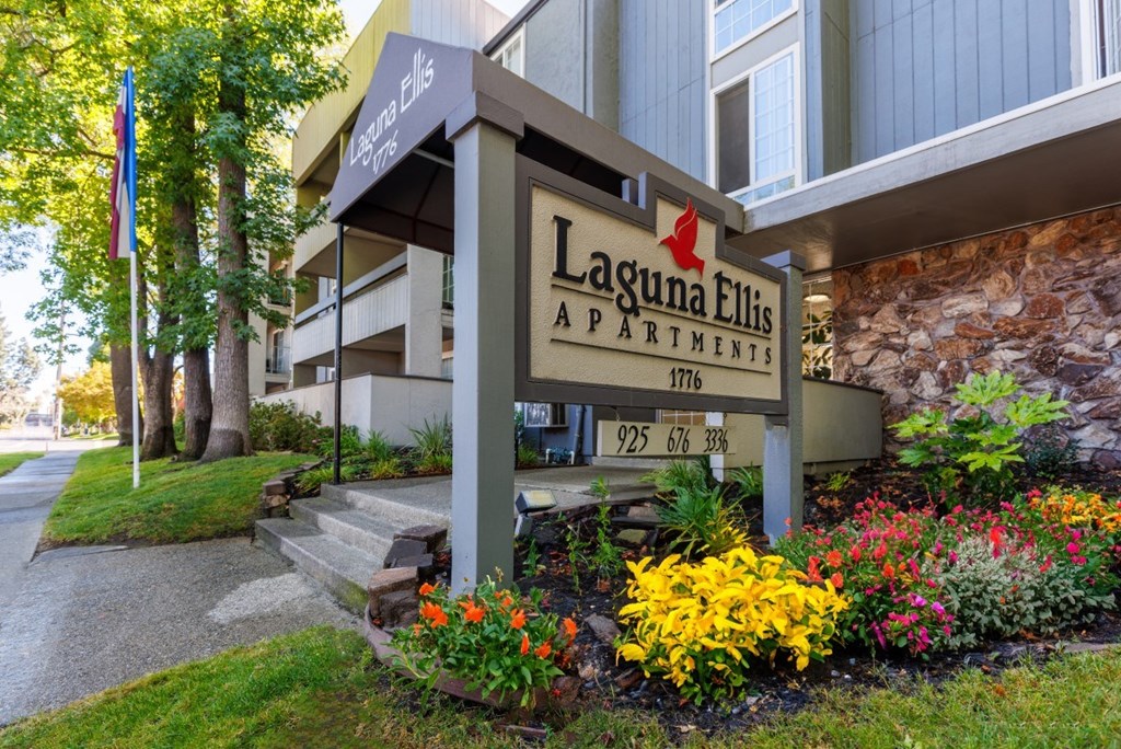 A sign for Laguna Ellis Apartments is displayed in front of a building.