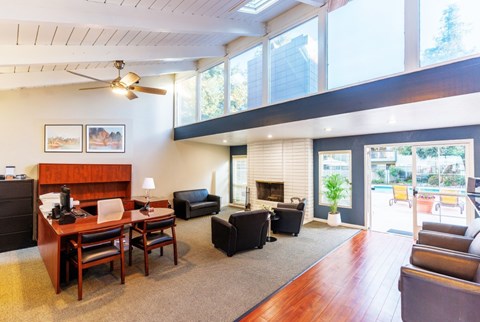 A living room with a fireplace and a ceiling fan.
