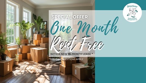 A room with boxes on the floor and a sign offering a one month rent free deal.