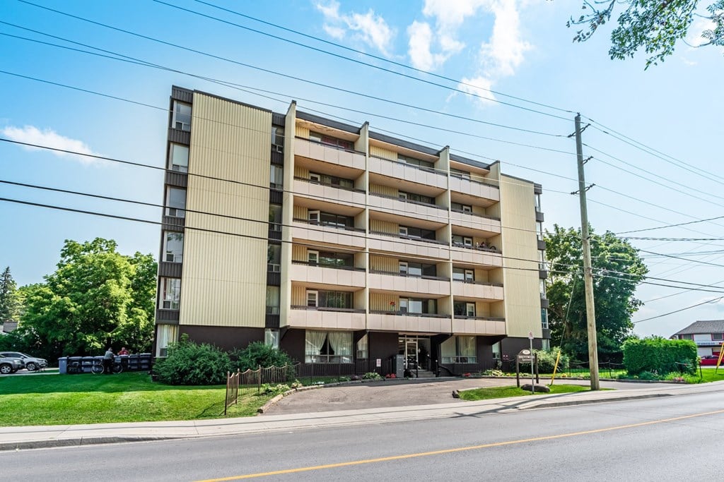 A large apartment building with multiple balconies and windows.