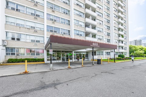 The image shows a large apartment building with the number 4415 on it.