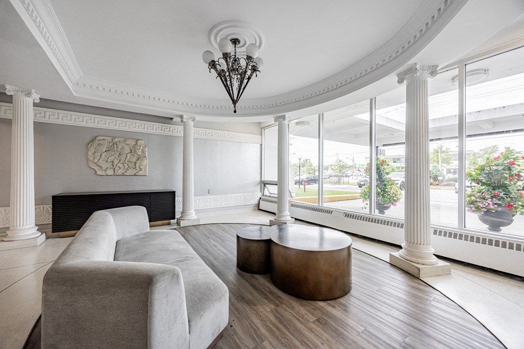 A living room with a fireplace and a chandelier.