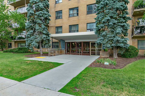 A building with a green lawn in front.