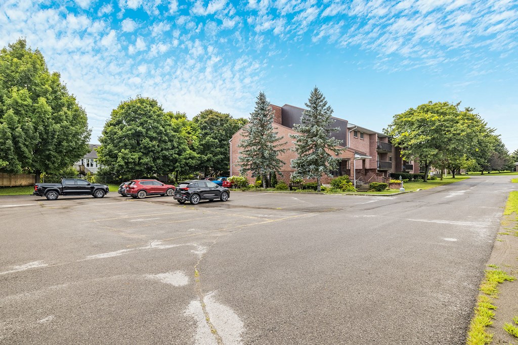 a parking lot with cars in front of a building