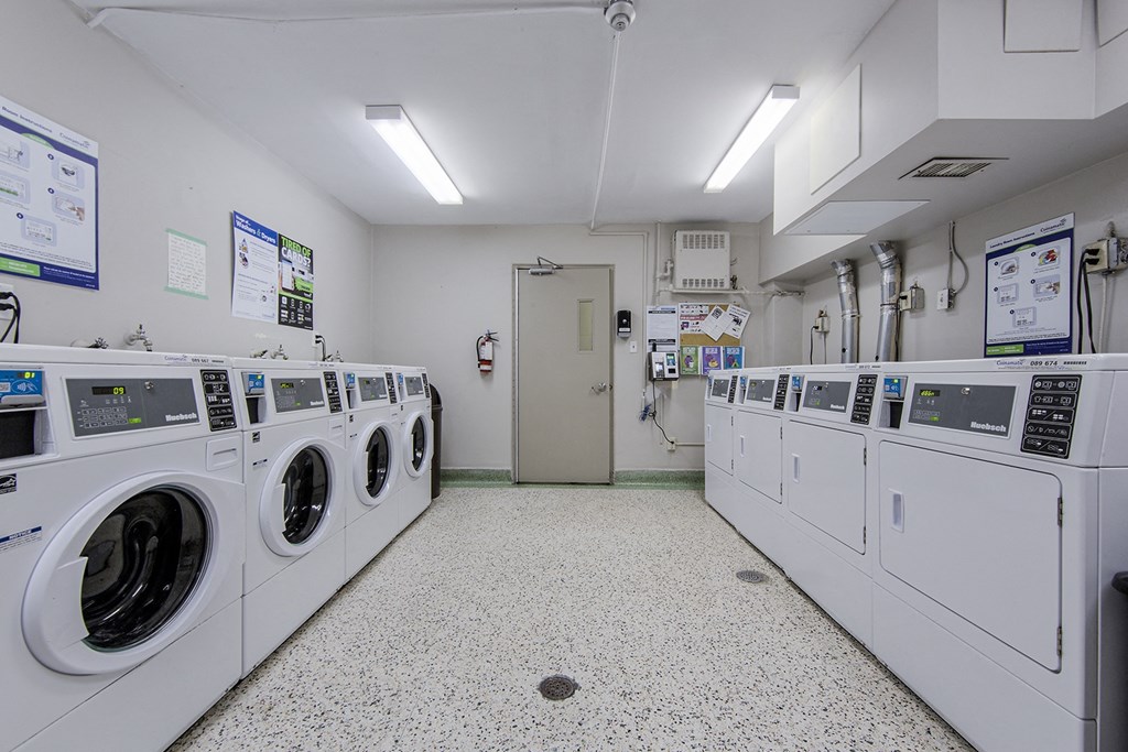 A row of washing machines in a laundromat.