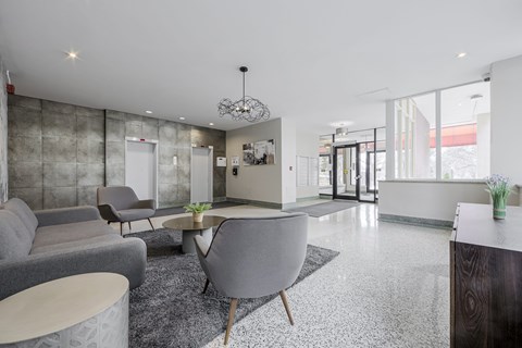 A modern living room with grey and white decor.