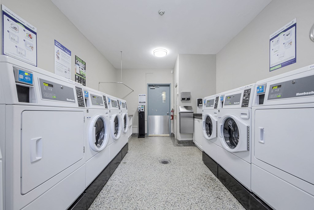 A row of washing machines in a laundromat.