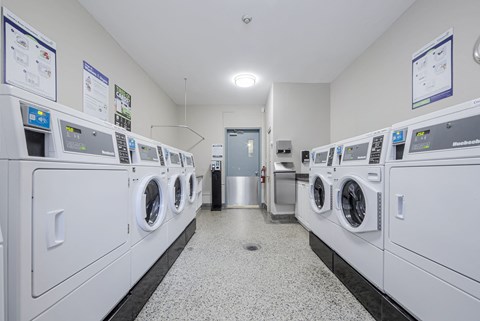 A row of washing machines in a laundromat.