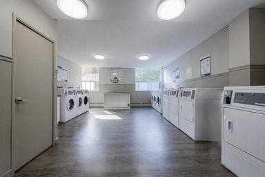 A laundry room with washers and dryers.