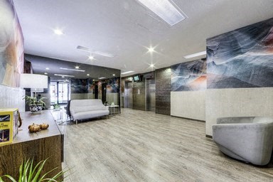 A modern office space with a large mural on the wall.
