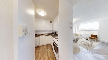 A white interior with a kitchen and living room.