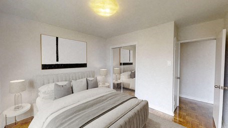 A bedroom with a large bed and a mirror above it.