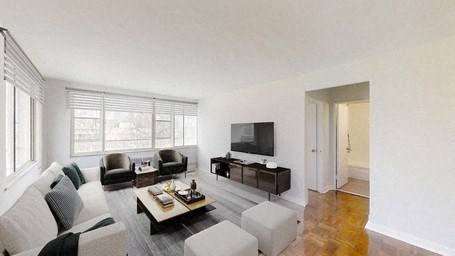 A living room with a couch, armchairs, and a coffee table.