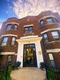 A brick building with a black door and windows.