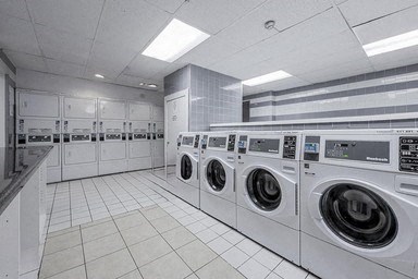 A row of washing machines in a laundromat.