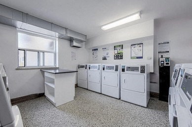 A laundry room with washers and dryers.