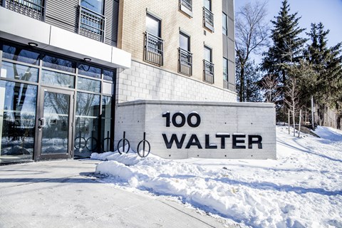 A building with a sign that says 100 Walter in front of it.