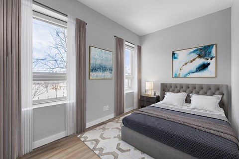 A bedroom with a large bed and two paintings on the wall.