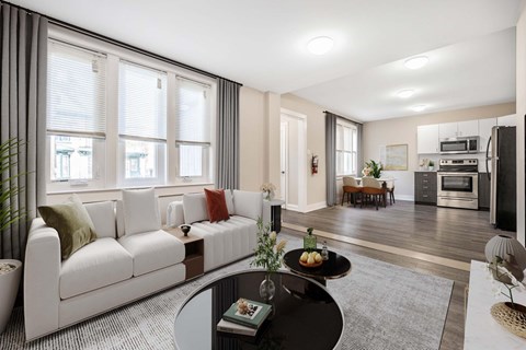 A modern living room with a white sofa and a black coffee table.
