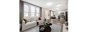 A modern living room with a white sofa and a black coffee table.