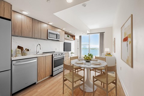 A modern kitchen with a dining table set for two.