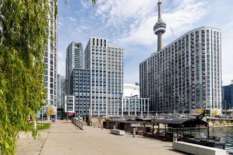 A cityscape with a large building featuring a spire in the background.