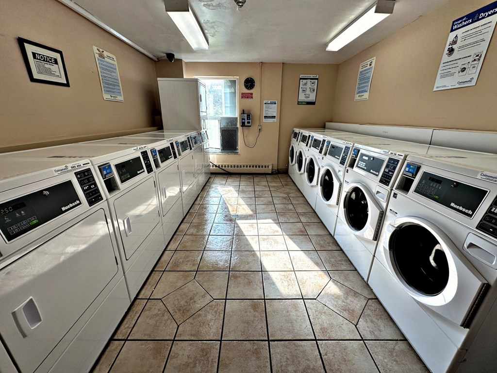 A laundromat with rows of washers and dryers.