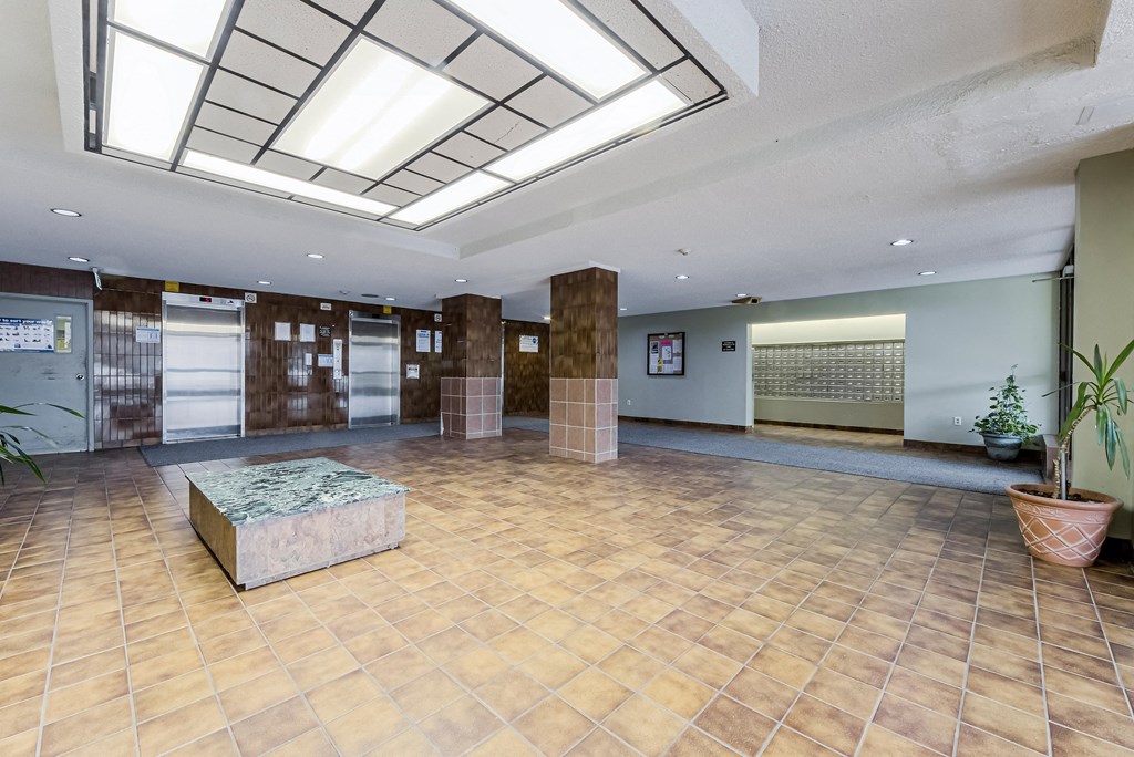 a large lobby with a stone bench in the middle of it